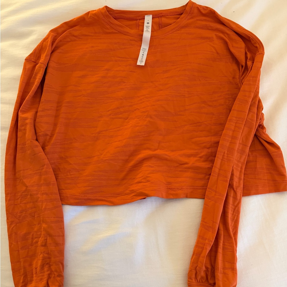 Lululemon Muscle Love Tiger Mesh Cropped long sleeve orange top. Size 6